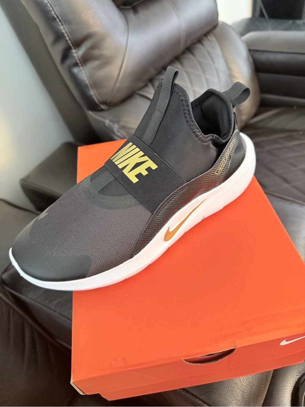 Nike Men’s Slip-On Sneakers in Black and Gold Accent